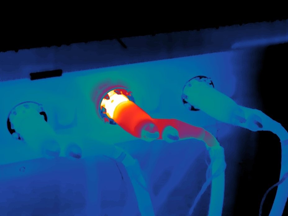 Infrared image of an electrical connector with a bright overheating conductor