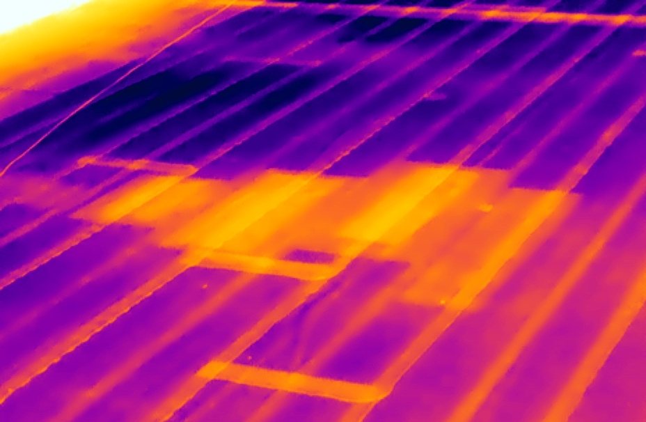 Aerial infrared image of a roof showing trapped moisture patterns